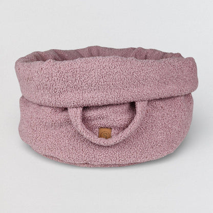Luxe teddy hondenmand in zacht roze met ronde vorm en opstaande rand